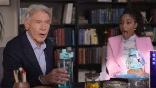 From left to right: Paul holding his small water bottle and talking and Gaby sitting next to him in shock with her mouth open. She's holding her massive water bottle.