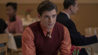 David Corenswet sitting at a table dressed in red and pink in Hollywood.