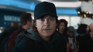 Jason Bateman with a hat and earpiece in Carry-On